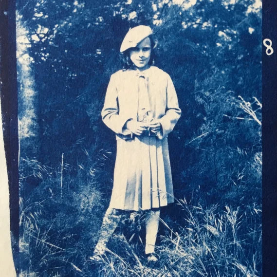 Portrait en cyanotype d'une fillette debout dans un jardin